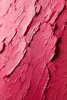 Macro view of pink lipstick texture with creamy strokes and ridges showing cosmetic product detail for beauty industry use.