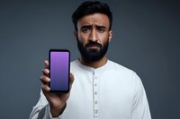 Confused bearded man holding smartphone with purple screen displaying puzzled facial expression in white shirt against gray background for technology concepts.