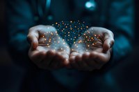 Cupped hands holding glowing network of golden light particles against dark blue background, symbolizing digital transformation and connectivity.