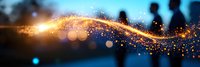 Abstract golden light trail with glowing sparkles and bokeh effect against blurred silhouettes of people in evening atmosphere, creating magical ambiance.