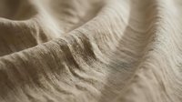 Beige linen fabric with soft folds and natural texture, suitable for textile design, fashion backgrounds, and interior decor projects.