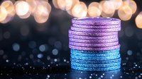 Stacked glittery poker chips in purple and blue colors on dark background with golden bokeh lights creating luxurious casino atmosphere.