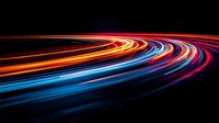 Vibrant light trails curve along dark background creating dynamic motion effect with red, orange and blue streaks, representing speed, technology and urban nightlife.