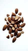 Whole and halved almonds arranged on white background, isolated and ready for food, nutrition, and healthy eating design projects.