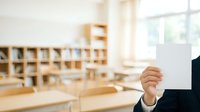 Businesswoman holding blank white card in modern office library workspace with wooden shelves and natural light for corporate branding.