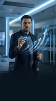 Professional businessman interacting with holographic financial growth charts and data analytics in modern office environment for business presentations.