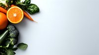 Fresh organic produce arrangement with orange, carrot, broccoli and spinach leaves on light background, corner border design for healthy eating concept.