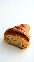 Croissant with golden, flaky layers and airy crumb structure isolated on white background. Suitable for bakery, food, and culinary design projects.