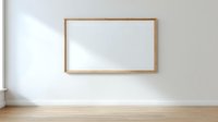Empty wooden frame hanging on white wall in minimalist room with natural light and wooden floor for mockup design projects.
