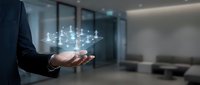 Businessman holding glowing network connections in modern office space representing digital transformation and connectivity solutions for corporate technology.