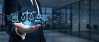 Businessman holding glowing legal icons including scales of justice and gavel, symbolizing law, justice, and digital legal services in modern office.