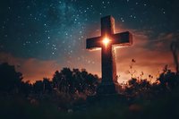 Stone cross silhouette against dramatic sunset sky with stars, symbolizing faith, spirituality, and remembrance in peaceful meadow setting.