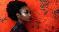 Young African American woman with natural curly hair in profile against vibrant red floral background, wearing black high-neck top, elegant makeup and pearl earring.