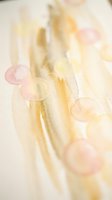 Soft abstract watercolor background with flowing golden yellow and pink tones creating dreamy artistic texture for creative projects and designs.