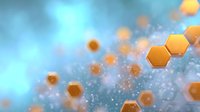 Orange hexagonal shapes floating in soft blue atmosphere with bokeh effect and glowing particles, creating modern scientific or technological background.