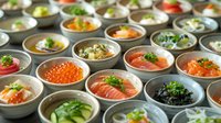 Assortment of fresh seafood dishes in ceramic bowls featuring salmon, caviar, and vegetables garnished with herbs for gourmet dining experience.