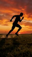 Silhouette of male athlete sprinting across open field during golden sunset, ideal for fitness, wellness, and sports marketing campaigns.