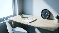 Minimalist workspace with wooden desk, black wall clock, white mug, notebook and small potted plant by bright window with natural sunlight.