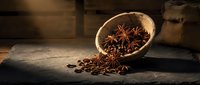 Aromatic star anise spices scattered from wooden bowl on rustic table surface for culinary cooking and baking recipes.