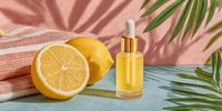 Natural vitamin C serum bottle with fresh lemon slices and tropical palm leaves on pastel background for skincare and beauty routine.