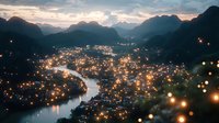 Aerial view of mountain town at dusk with glowing lights reflecting in winding river, dramatic mountain silhouettes and moody twilight sky creating atmospheric scenery.