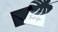 Elegant thank you card with black envelope on light gray background, monstera leaf shadow overlay, minimalist style for greeting and stationery design.
