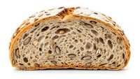 Artisan multigrain bread slice with seeds and nuts showing detailed texture and airy crumb structure isolated on white background for culinary designs.