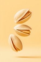 Flying pistachio nuts in shells on beige background, levitating in air with soft shadows, minimalist food photography composition for healthy snacks advertising.
