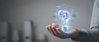 Businessman holding glowing lightbulb with AI brain hologram and digital icons, representing artificial intelligence innovation and smart technology solutions for business.