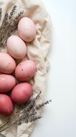 Pink speckled Easter eggs with dried lavender on linen fabric creating rustic spring holiday decoration with natural organic aesthetic and copy space.