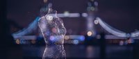 Silhouette of a woman with glowing particle effects and digital light trails, representing innovation, technology, and transformation in business and corporate environments.