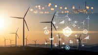 Wind turbines generating renewable energy with digital technology interface overlay displaying data analytics and smart grid connectivity at sunset.