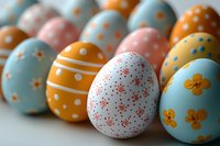 Colorful Easter eggs decorated with dots, stripes, and floral patterns in pastel blue, orange, pink, and white create festive holiday composition on light background.