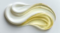 Creamy white and yellow cosmetic product swirls on white background, showcasing luxurious texture for skincare advertising.