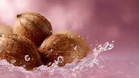 Fresh coconuts with splashing water drops on pink background, dynamic food photography composition with tropical fruits and liquid motion effect.
