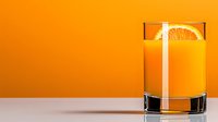 Fresh orange juice in transparent glass with citrus slice garnish on orange background, minimalist drink photography for menu and advertising.