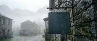 Atmospheric medieval stone village street shrouded in thick fog with ancient cobblestones and traditional architecture creating mysterious ambiance.