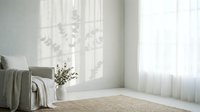 Minimalist bedroom interior with natural light streaming through sheer curtains, neutral tones and cozy textiles creating serene atmosphere for relaxation.