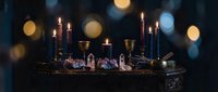Mystical altar setup with burning candles, crystals, and ritual objects creating atmospheric spiritual ambiance for meditation and esoteric practices.