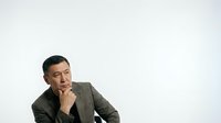 Asian male professional in business casual attire, hand to chin in thoughtful pose, contemplative expression suitable for corporate, leadership, and business concept projects.