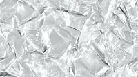 Crumpled aluminum foil texture with metallic silver surface and reflective wrinkled patterns for kitchen cooking and food packaging design backgrounds.
