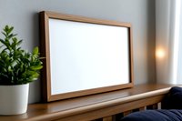 Wooden frame mockup with blank white canvas on shelf next to green plant in pot against gray wall with soft lighting, modern home interior decor.