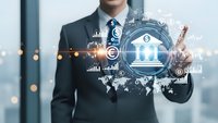 Professional businessman in dark suit touching digital banking interface with financial icons, charts and global network connections in modern office.