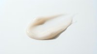 Creamy beige cosmetic texture smear isolated on white background for skincare and beauty product design applications.