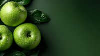 Fresh green apples covered in water drops on dark background with leaves. Macro shot showing texture and natural moisture on fruit surface. Healthy organic produce.