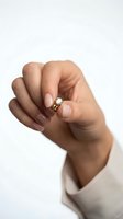 Close-up of a woman's hand displaying an elegant diamond engagement ring with a solitaire stone setting on white background, perfect for jewelry marketing and wedding-related designs.