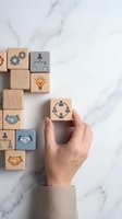 Hand placing wooden cube with teamwork icon among business concept blocks on marble surface for corporate strategy and leadership development.