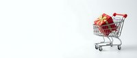 Miniature shopping cart filled with red gift boxes and gold ribbons on white background, isolated for retail and holiday commerce design projects.