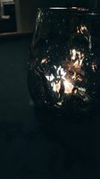 Glowing string lights inside clear glass jar on dark surface, warm ambient lighting for home decor, events, and interior design projects.