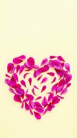 Pink flower petals arranged in heart shape on cream background for romantic Valentine's Day greeting cards and love themed designs.